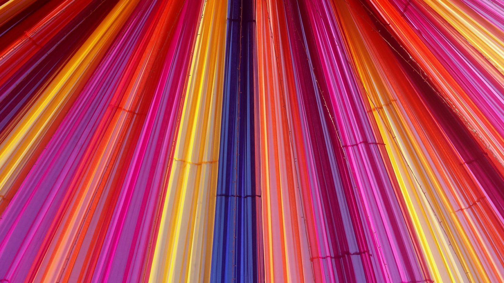Coloured strips of plastic lined up next to each other to form an eye-catching screen.